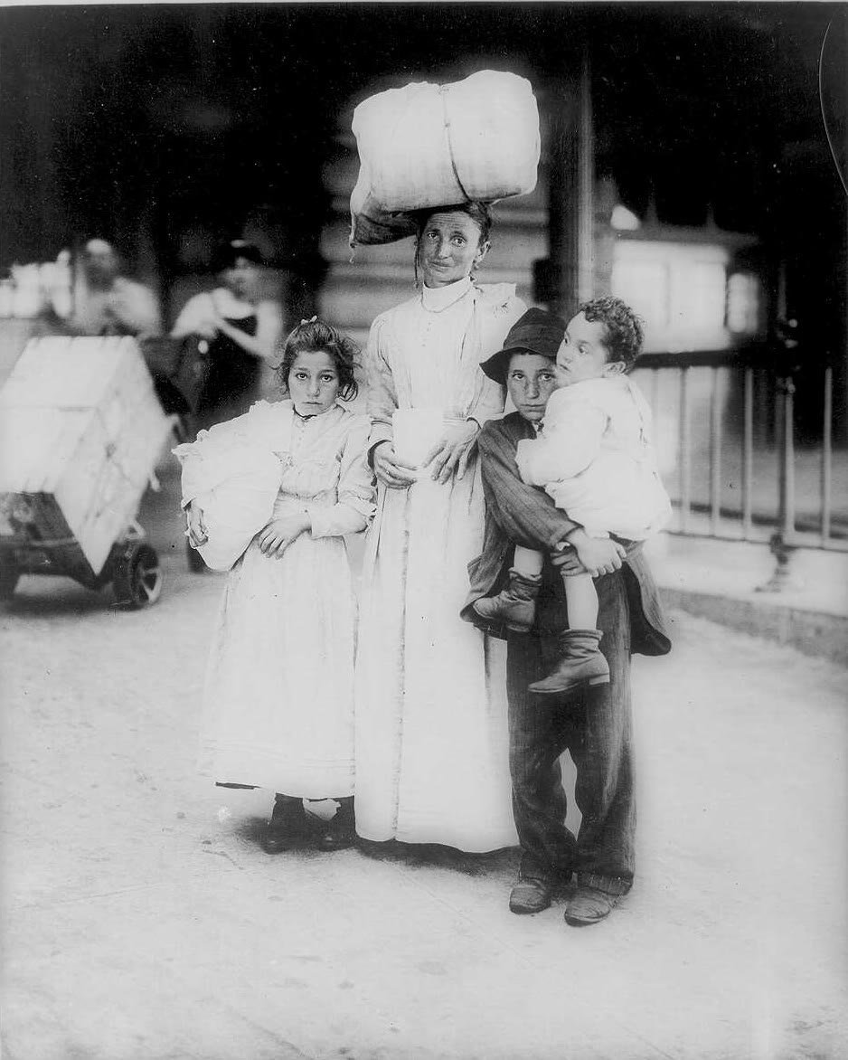 An Italian immigrant mother and three children at Ellis Island, early 1900s